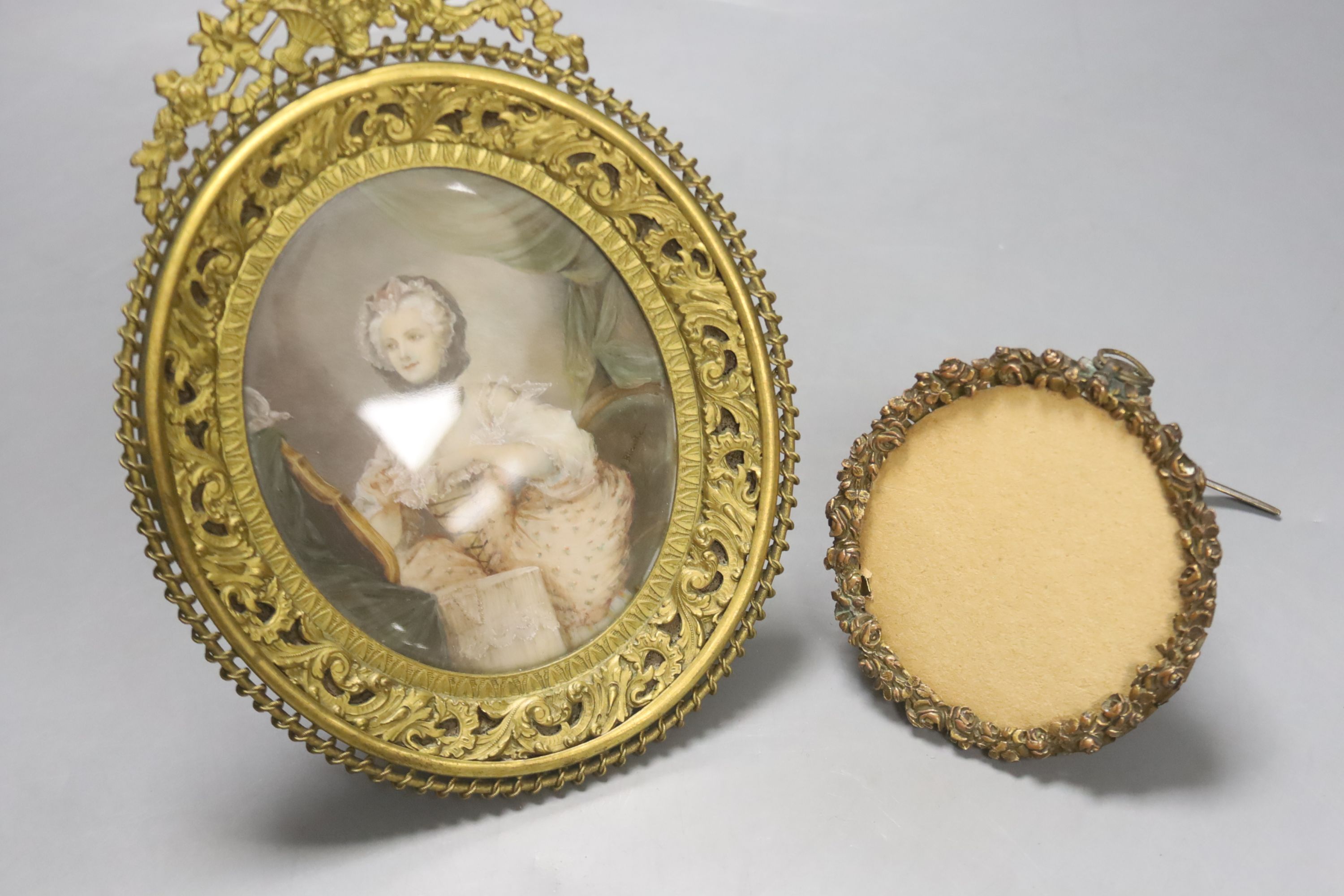 A Victorian framed miniature (snuff box lid) of children in a nursery, another miniature and three small frames, largest 10cm diameter